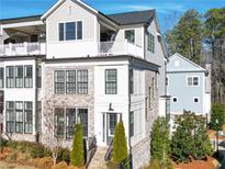 Beautiful, multi-level townhome with a brick facade and private balcony at 324 Concord St, Alpharetta, GA 30009