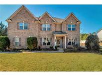 Charming brick two-story home with a well-maintained lawn and mature landscaping at 200 Claret Way, Mcdonough, GA 30252