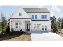 Two-story home with white siding, dark roof, and a covered entryway, plus a concrete driveway at 128 Kingsley Way, Acworth, GA 30102