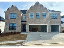 Two-story brick home with a two-car garage and freshly sodded front yard at 4035 Hosch Retreat Dr, Buford, GA 30519