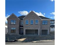 Two-story brick home with three-car garage and large windows at 4035 Hosch Retreat Dr, Buford, GA 30519