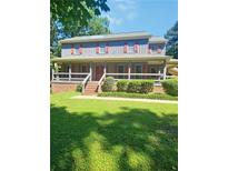 Charming two-story home featuring a cozy covered front porch at 4449 Inns Brook Dr, Snellville, GA 30039