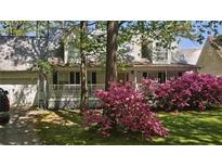 Two-story house with wraparound porch and blooming azaleas at 3979 Doral Cir, Atlanta, GA 30360