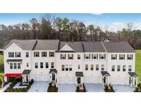 Modern townhome exteriors feature white brick, black shutters, and individual garages at 250 Lytham Se Dr, Mableton, GA 30126