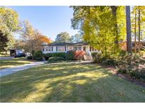 Charming ranch home with a manicured lawn and mature trees at 1260 Amanda Cir, Decatur, GA 30033