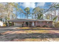 Brick ranch house with carport and landscaped yard at 1265 Bethsaida Rd, Riverdale, GA 30296
