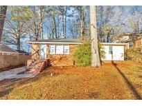 Brick ranch home with a landscaped yard and steps leading to the front entrance at 2259 Nelms Sw Dr, Atlanta, GA 30315
