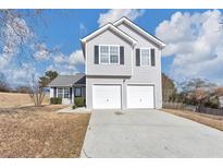 Two-story house with a gray exterior and a two-car garage at 1162 Misty Meadows Xing, Hampton, GA 30228