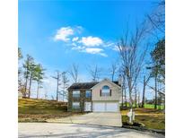 Two-story house with stone accents and a two-car garage, nicely landscaped at 6921 Foxmoor Way, Douglasville, GA 30134