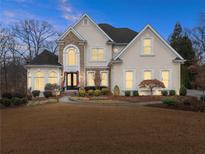 Two-story house with stone accents and a manicured lawn at 2960 Millwater Xing, Dacula, GA 30019