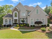 Stunning two-story home boasts a manicured lawn and beautiful landscaping at 2960 Millwater Xing, Dacula, GA 30019
