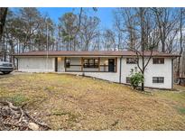 Charming ranch home with white brick exterior and covered porch at 570 N Burnt Hickory Rd, Douglasville, GA 30134