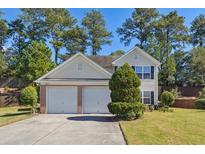 Two-story house with a two-car garage and well-maintained lawn at 1331 Pine Acre Dr, Sugar Hill, GA 30518