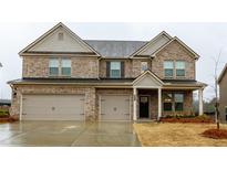 Beautiful two-story brick home with attached two-car garage and covered front porch at 3004 Amabile Rd, Dacula, GA 30019