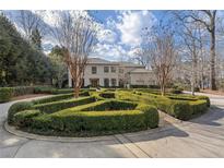 Stunning two-story home with manicured landscaping and circular driveway at 1500 W Wesley Nw Rd, Atlanta, GA 30327