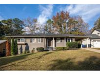 Gray brick ranch house with a well-manicured lawn at 1863 Derrill Dr, Decatur, GA 30032