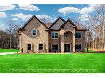 Stunning two-story brick home featuring a manicured lawn, stately architecture, and inviting curb appeal on a sunny day at 2571 Se Ebenezer Rd, Conyers, GA 30094
