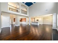 Spacious living room with hardwood floors, high ceilings, and open floor plan to kitchen and dining areas at 2571 Se Ebenezer Rd, Conyers, GA 30094