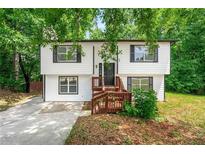 Charming two-story home with a landscaped yard and welcoming entryway, surrounded by lush trees at 2290 Wilkins Cv, Decatur, GA 30035