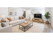 Bright living room features neutral decor, wood floors, a comfortable sofa, and stylish furnishings at 2290 Wilkins Cv, Decatur, GA 30035