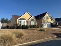 Charming single-Gathering home featuring manicured landscaping and a well-maintained lawn at 1060 S Creek Dr, Villa Rica, GA 30180
