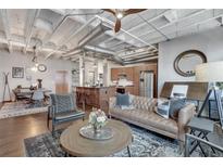 Open concept living space features exposed ductwork and hardwood floors at 878 Peachtree Ne St # 535, Atlanta, GA 30309