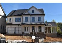 Two-story home features a front porch, gray roof, and white siding at 3065 Barnes Mill Ct, Roswell, GA 30075