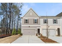 Charming townhome with a well-manicured lawn and attached garage, creating an inviting curb appeal at 401 Carrera Ln, Acworth, GA 30102
