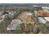 Aerial view of new townhome community, featuring multiple buildings and surrounding landscape at 417 Carrera Ln, Acworth, GA 30102