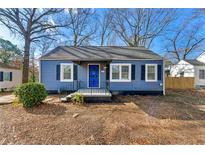 Charming blue house with a white trim and a small front porch at 540 Hamilton E Holmes Nw Dr, Atlanta, GA 30318