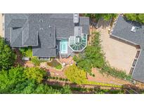 Stunning aerial view of a luxury home featuring a spa, sunroom, brick patio, koi pond, and beautifully landscaped grounds at 117 N Cove Dr, Peachtree City, GA 30269