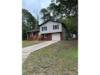 Brick ranch home with attached garage and landscaping at 1685 Kinglet Rd, Jonesboro, GA 30238