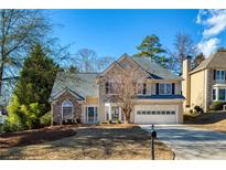 Two-story house with stone accents and a large front yard at 5375 Ashwind Trce, Alpharetta, GA 30005