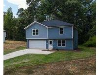 Newly built 2-story house with a gray driveway and attached garage at 1351 E Atlanta E Rd, Stockbridge, GA 30281