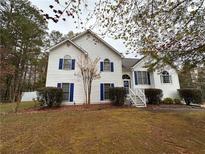 Two-story house with white siding, blue shutters, and a landscaped yard at 8255 Stonebrook Dr, Cumming, GA 30040