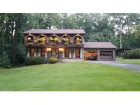 Two-story house with a brick garage and landscaping at 4567 Town Crier Sw Rd, Lilburn, GA 30047