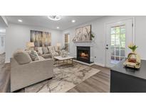 Spacious living room with fireplace and hardwood floors at 9404 Cypress Ln, Jonesboro, GA 30238