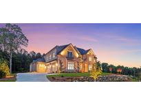 Stunning two-story home with a stone facade, manicured lawn, and a three car garage at 4927 Slaton Drive, Acworth, GA 30101