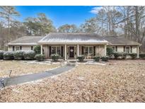Ranch style home with covered porch and landscaped yard at 304 Winding Stream Trl, Hampton, GA 30228