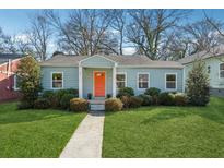 Charming single-story home with light blue siding, an orange front door, and well-maintained landscaping at 67 Holly Nw Rd, Atlanta, GA 30314