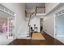 Bright entryway with hardwood floors, elegant staircase, and access to other rooms at 610 Ashwood Ct, Woodstock, GA 30189