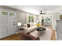 Light-filled living room features hardwood floors, a neutral color palette, and access to dining area at 3524 Brookfield Ln, Decatur, GA 30032