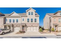 Two-story townhome with brick and siding exterior, two-car garage, and driveway at 1635 Coasta Way, Mableton, GA 30126