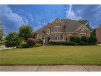 Brick house with landscaped lawn and large windows at 3374 Islesworth Trce, Duluth, GA 30097