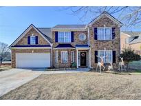 Brick two-story house with a large front yard, attached garage, and decorative deer statues at 861 Chandler Rd, Lawrenceville, GA 30045
