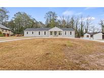 Newly renovated house with a large front yard and long driveway at 1320 Melbenan Dr, Atlanta, GA 30311