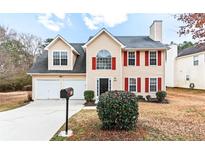 Charming two-story home with attached two-car garage and well-maintained front yard at 2916 Ward Lake Way, Ellenwood, GA 30294