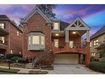 Brick front exterior of charming two-story home with attached garage at 1135 Fairway Ne Gdns, Brookhaven, GA 30319