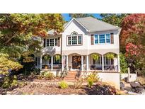 Two-story house with white siding, brown accents, and a wraparound porch at 314 Sandalin Ln, Peachtree City, GA 30269