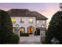 Elegant two-story home with stone driveway and manicured landscaping at 350 Woodward Nw Way, Atlanta, GA 30305